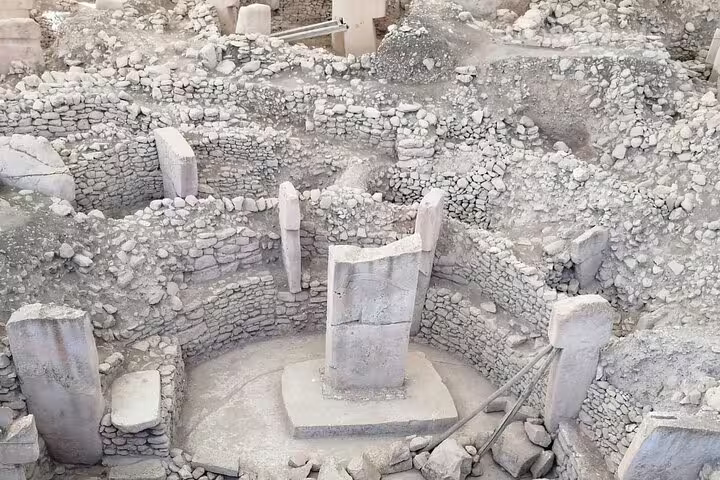 Gobeklitepe excavation site with T-shaped limestone pillars and circular stone walls on private Turkey tour