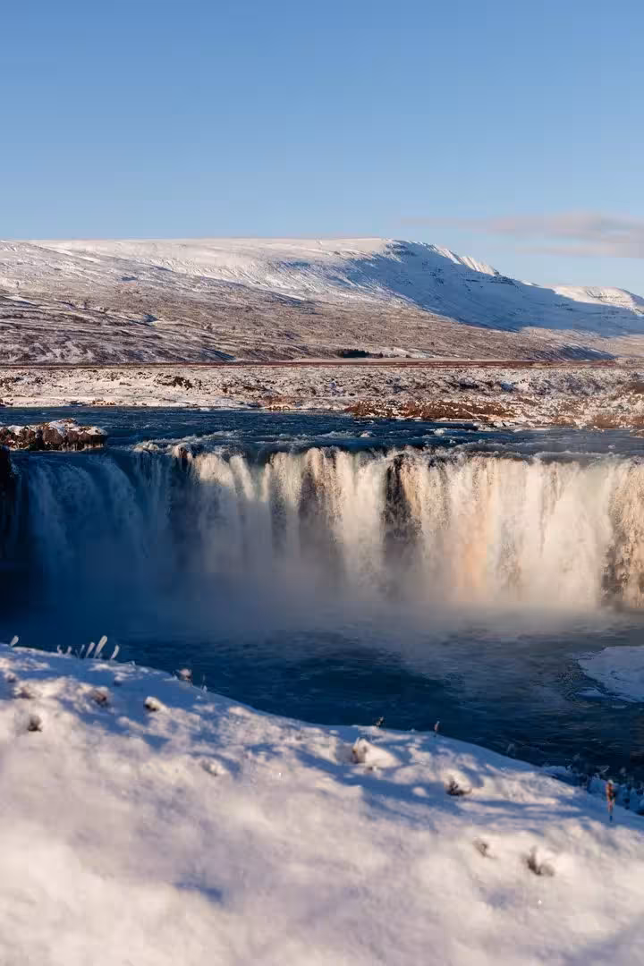 Goðafoss Waterfall in snowy North Iceland, scenic stop on private Sacred Iceland adventure and Christmas cacao ceremony