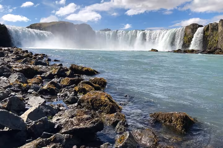 Majestic Godafoss waterfall cascading under a blue sky, a must-see on Lake Myvatn private day tour.