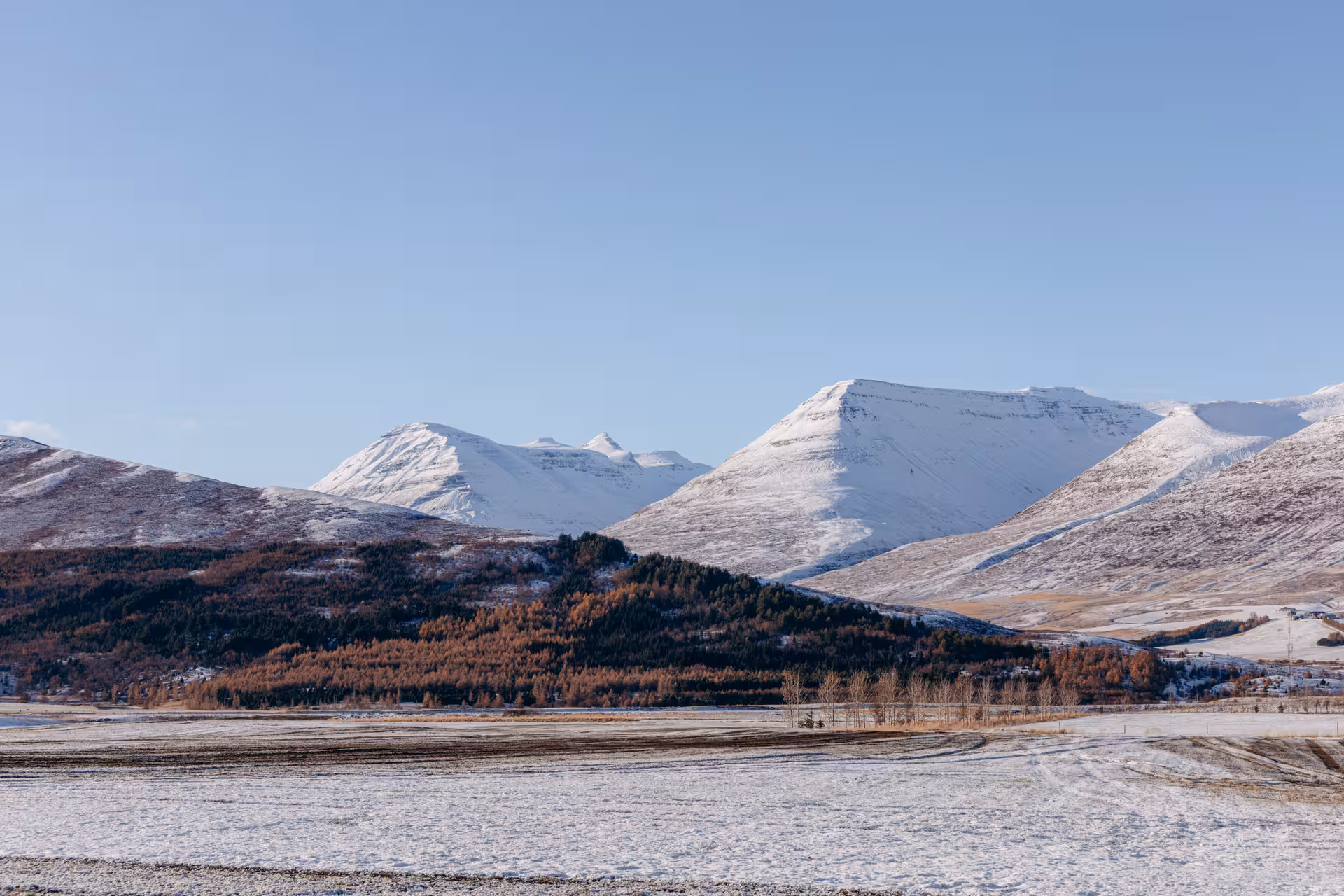 Snowy North Iceland mountains and valleys on Northern Wonders day tour to Goðafoss, Christmas House and Forest Lagoon