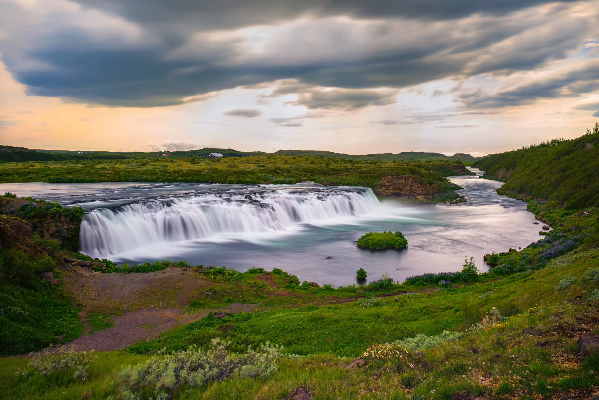 Goðafoss waterfall at sunset over lush valley, featured on a Private Golden Circle Extended Tour from Reykjavik
