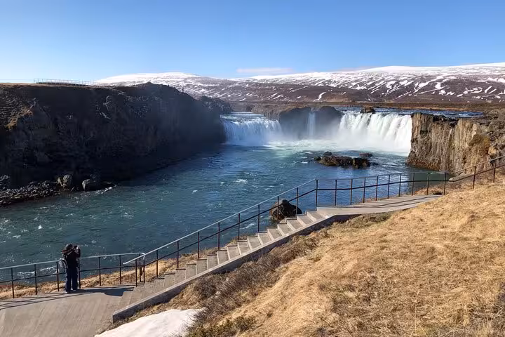 Scenic walkway leading to Godafoss Waterfall, perfect for a guided day tour from Akureyri.