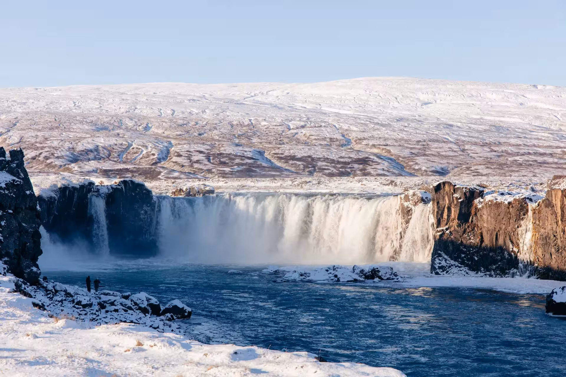 Goðafoss Waterfall in winter, North Iceland private tour stop with snowy cliffs and icy river views