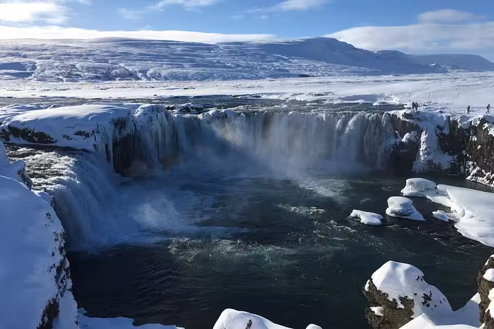 Snow-covered Godafoss Waterfall in winter, a breathtaking stop on the Lake Myvatn cruise ship day tour from Akureyri.