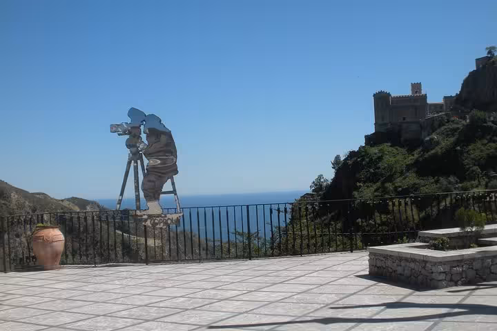 Terrace with a silhouette of a filmmaker and coastal views in Savoca, highlighting a filming location from The Godfather.