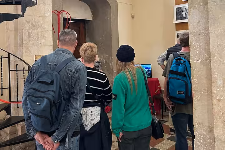 Visitors exploring a historical exhibit on 'The Godfather' tour, immersed in the rich cultural heritage of Sicily.