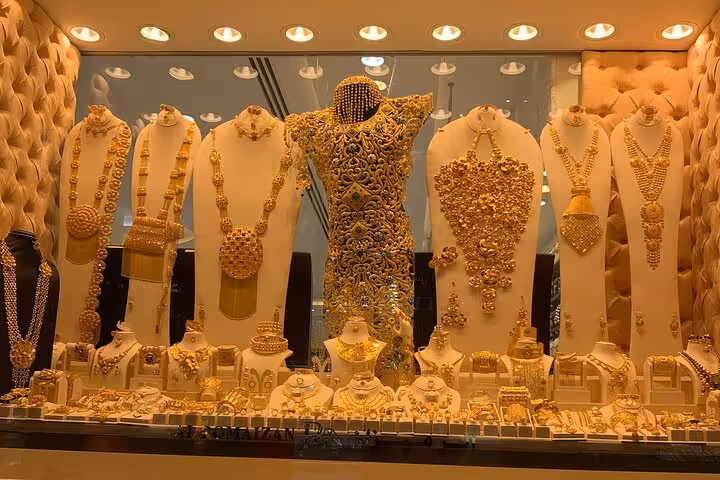 Gold jewelry shop window in Dubai Old Souk, traditional market stop on Dubai Creek sunset tour