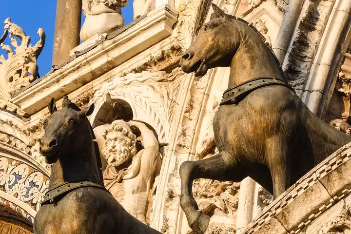 Bronze horses on the ornate façade of The Golden Basilica, showcasing exquisite Venetian art and architecture.