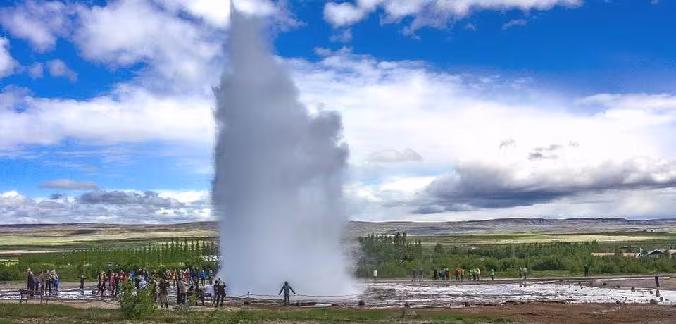 Visitors witness a powerful geyser eruption in Iceland's geothermal area on the Private Express Golden Circle tour.