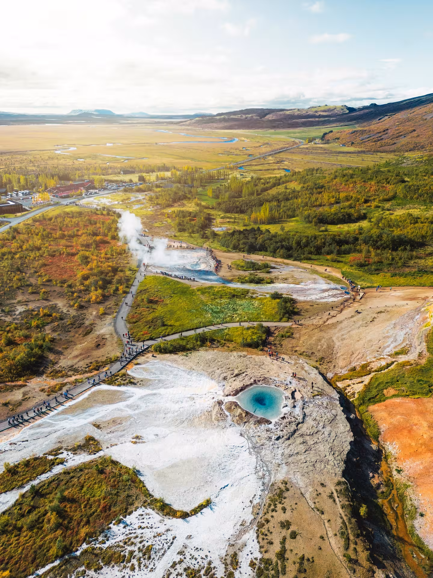 Aerial view of Geysir geothermal area with steaming hot springs and blue pool, Iceland Golden Circle