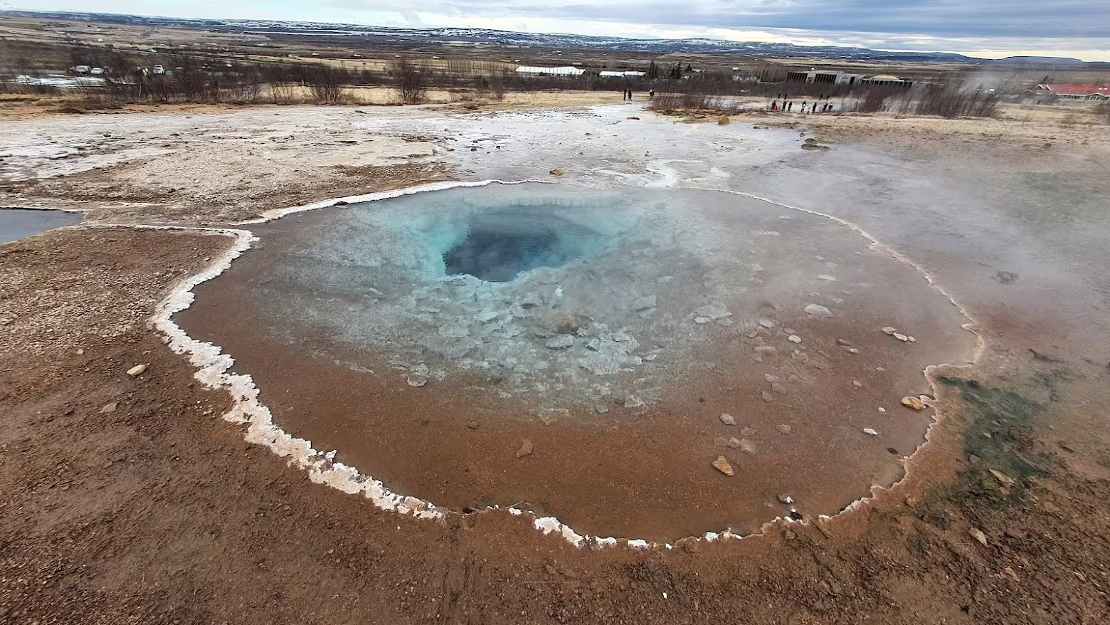 Turquoise hot spring pool at Geysir geothermal area on Iceland's Golden Circle route
