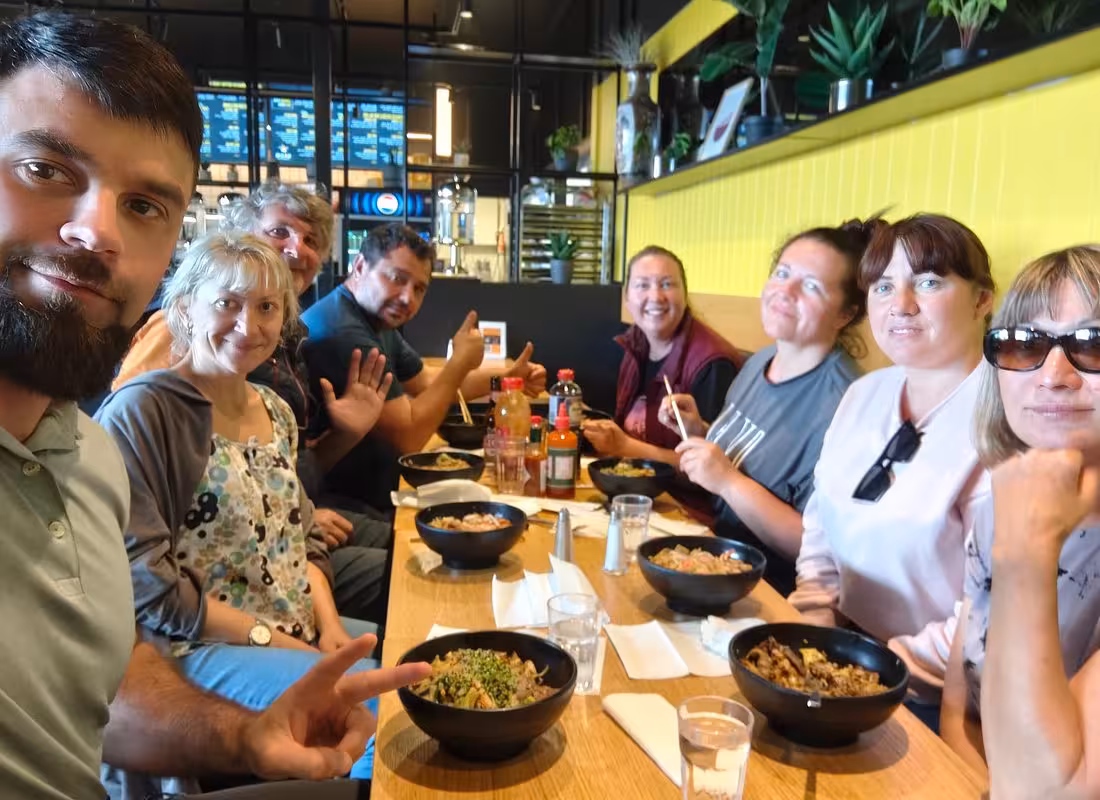 Tour group enjoying bowls of food at a restaurant in Reykjavik during Golden Circle South Coast tour
