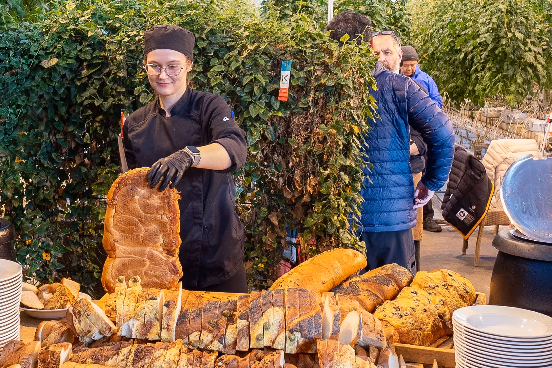 Chef serving assorted artisan breads at a Golden Circle tour lunch buffet in Iceland