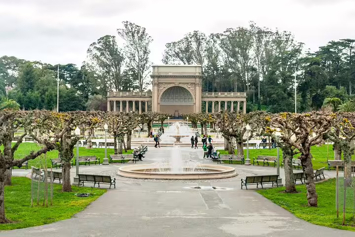 Tree-lined promenade with fountain leading to Music Concourse bandshell in Golden Gate Park, San Francisco