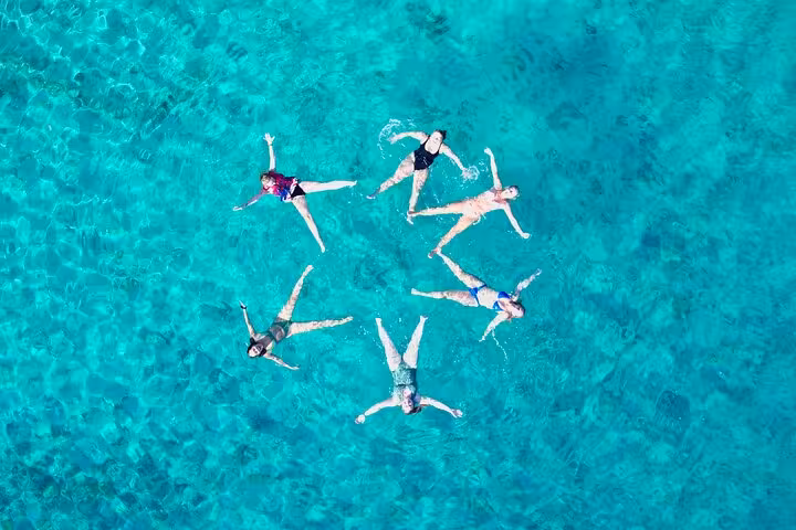 Aerial view of guests floating in turquoise Adriatic sea during Golden Horn Beach and Hvar private boat tour