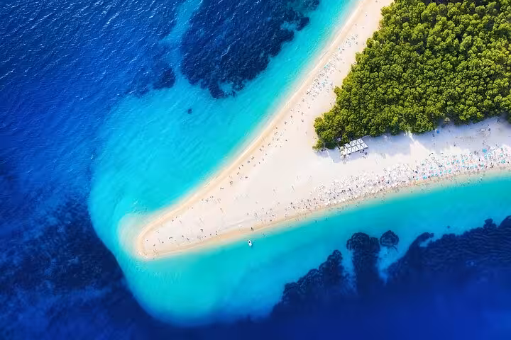 Aerial of Golden Horn Beach, Brač, with turquoise water and pine forest stop on Hvar private boat tour