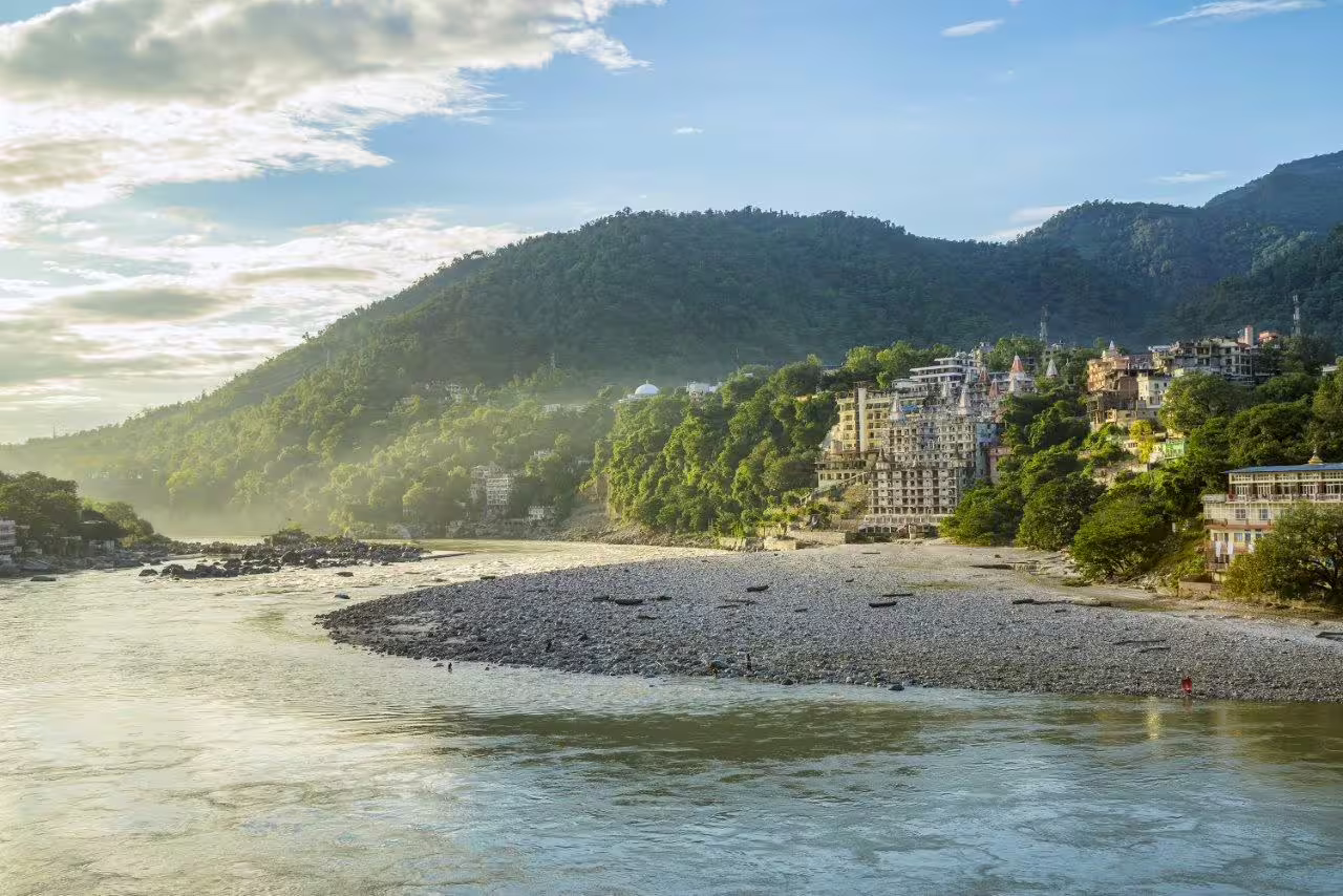 Scenic view of Rishikesh with lush hills and serene Ganges, ideal for Golden Triangle tour with Haridwar and Rishikesh.