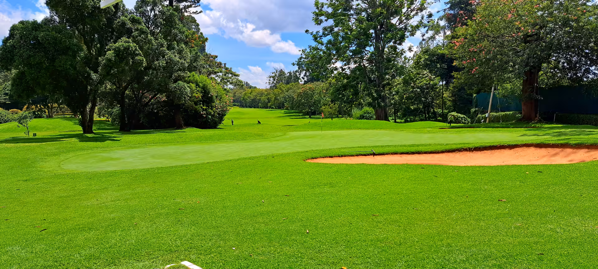 Pristine golf course with vibrant greenery and sand bunkers, perfect for a Great Rift Valley golf adventure.