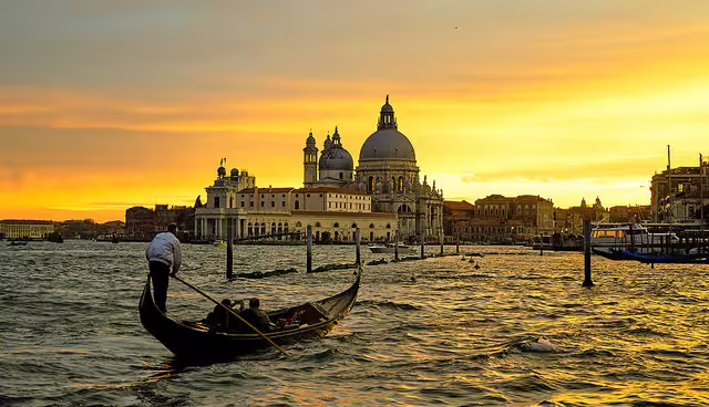 Gondola gliding at sunset near Santa Maria della Salute, romantic highlight of 2-day Venice trip from Rome