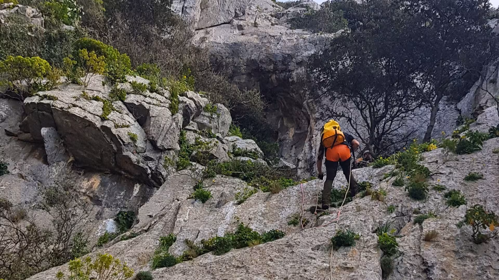 Adventurer navigating rugged terrain in Monte San Giovanni during a Gonnesa dry canyoning expedition.