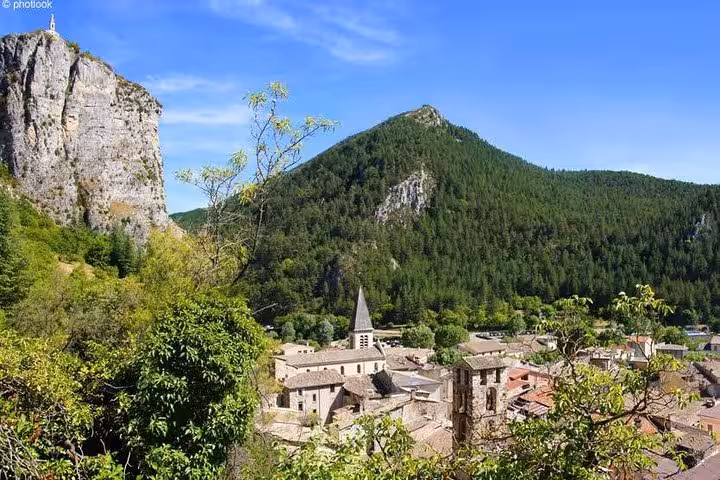 Medieval village nestled among limestone cliffs and forested hills in the Gorges du Verdon region, France