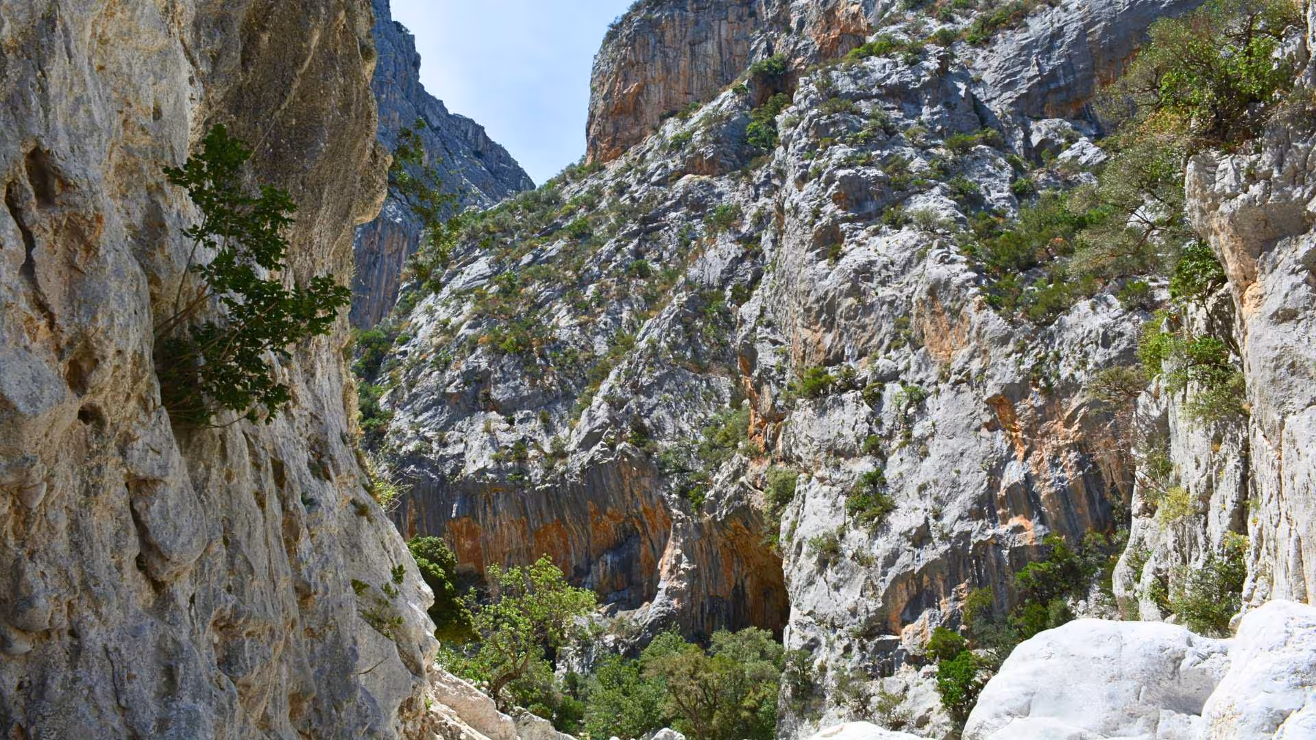 Majestic limestone cliffs of Gorropu Canyon, Sardinia, offering stunning views for trekking enthusiasts.