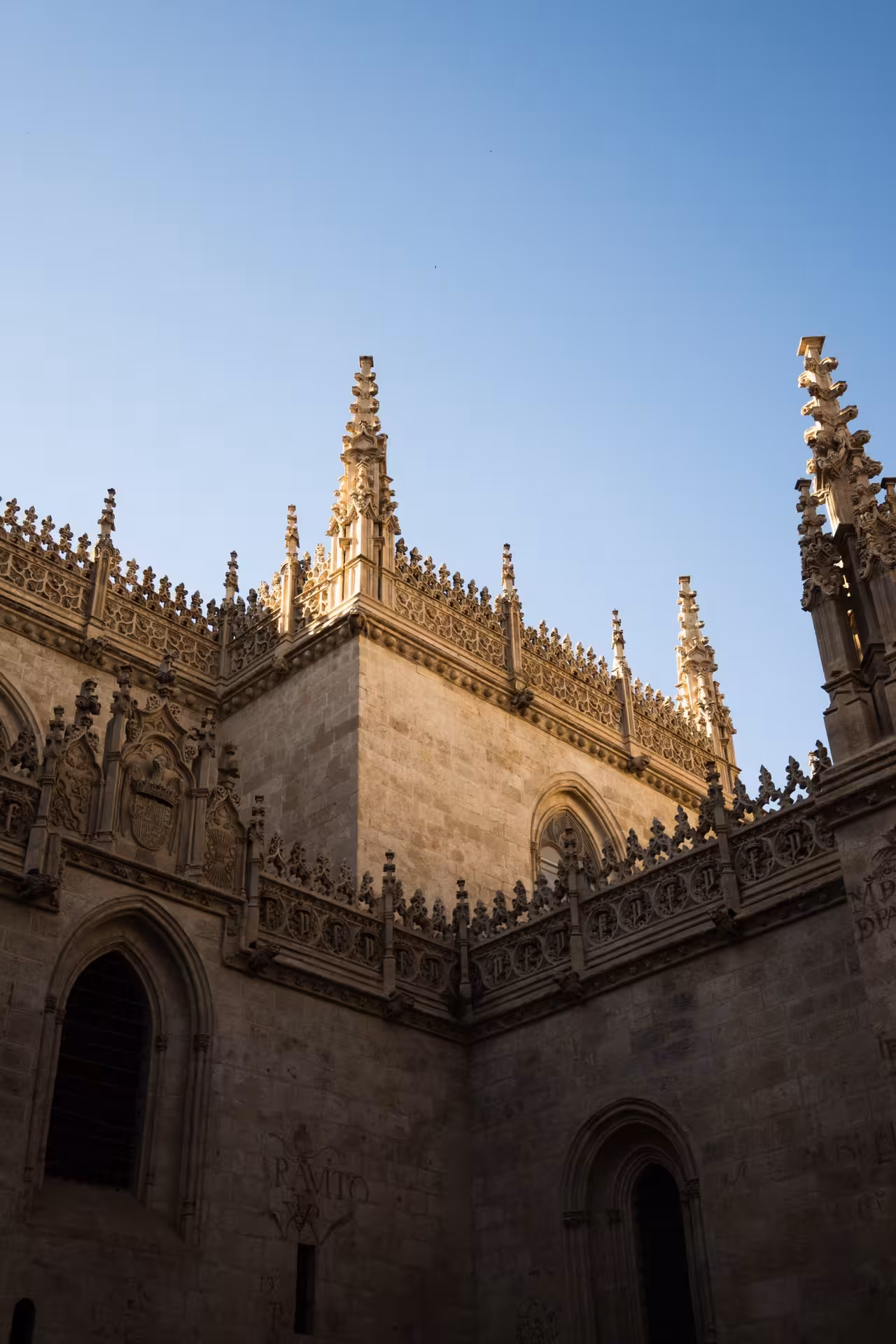 Gothic architecture of cathedral exterior under clear blue sky on guided tour with admission included.