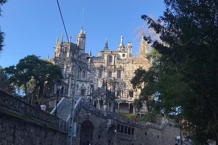 Majestic gothic palace in Sintra surrounded by trees, captured during an exclusive Jeep tour of Sintra-Cascais.