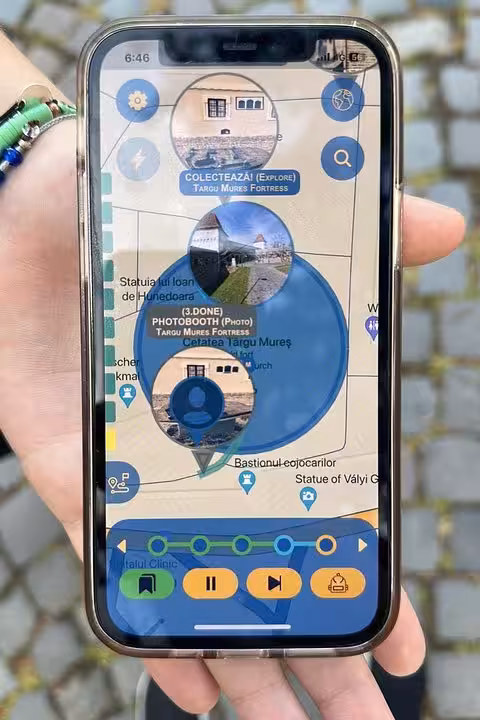 Hand holding smartphone displaying GPS scavenger hunt app with interactive map and landmark clues for self-guided walking tour