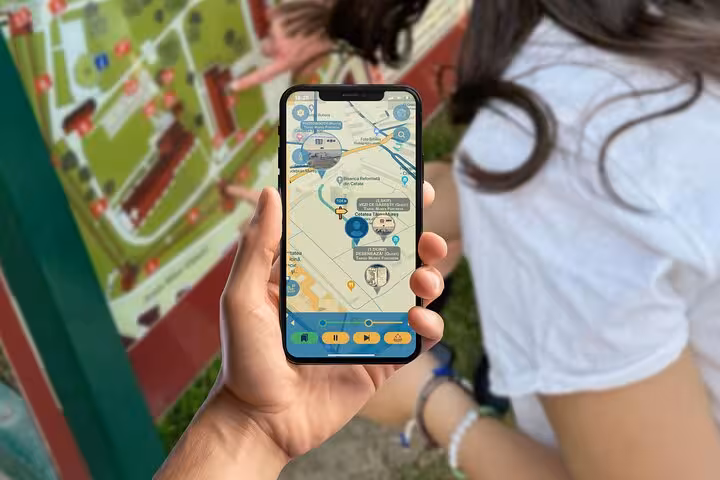 Tourist using self-guided GPS scavenger hunt app on smartphone with interactive map near outdoor city landmark walking tour