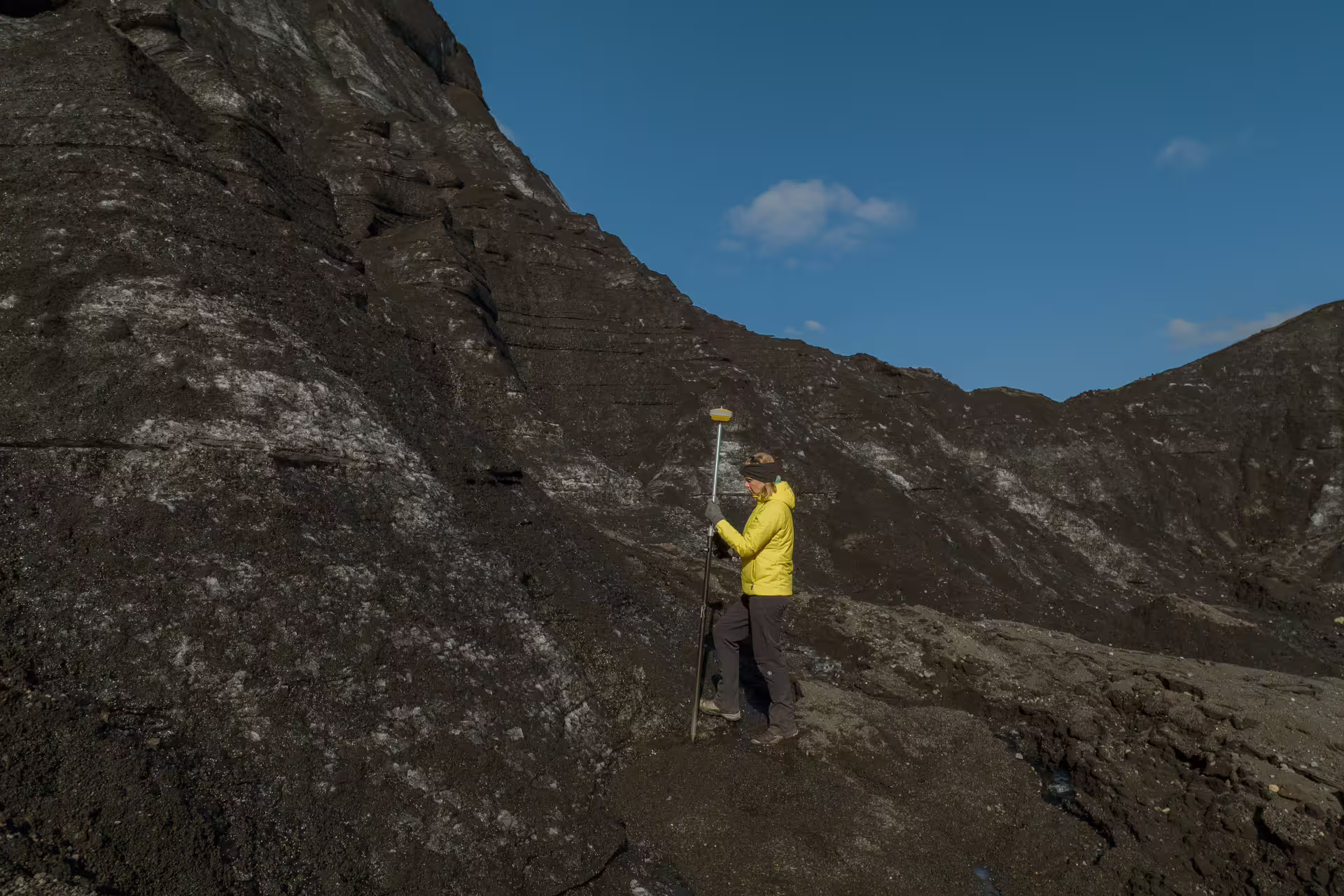 Guide using GPS survey equipment to map dead ice terrain on Katla Glacier full-day guided glaciological tour Iceland