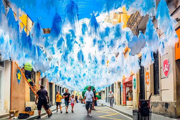 Decorated Gràcia street in Barcelona during Festa Major, seen on a vermouth and local tastings walking tour