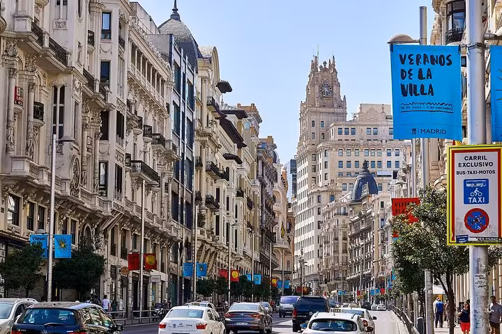 Bustling Gran Vía street in Madrid, showcasing urban vibrancy on the Granada, Toledo & Madrid 2-day tour.