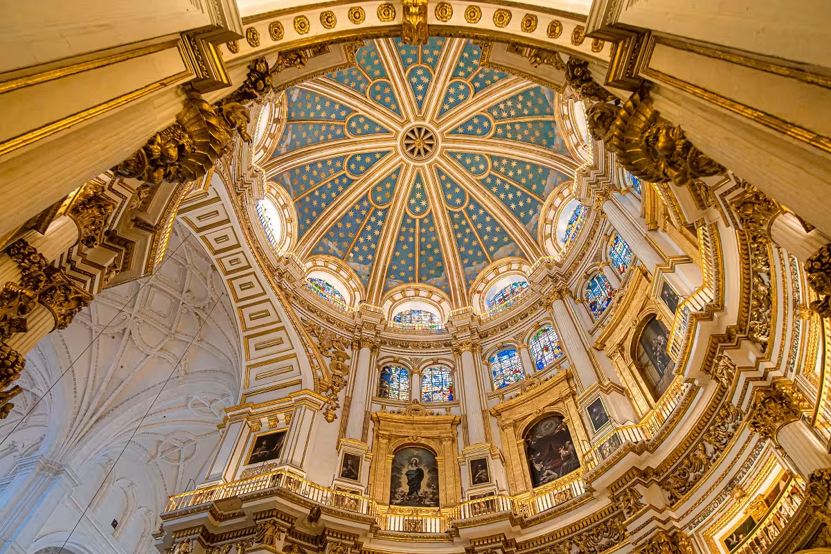 Stunning interior view of Granada Cathedral's ornate dome, showcasing intricate designs and stained glass.
