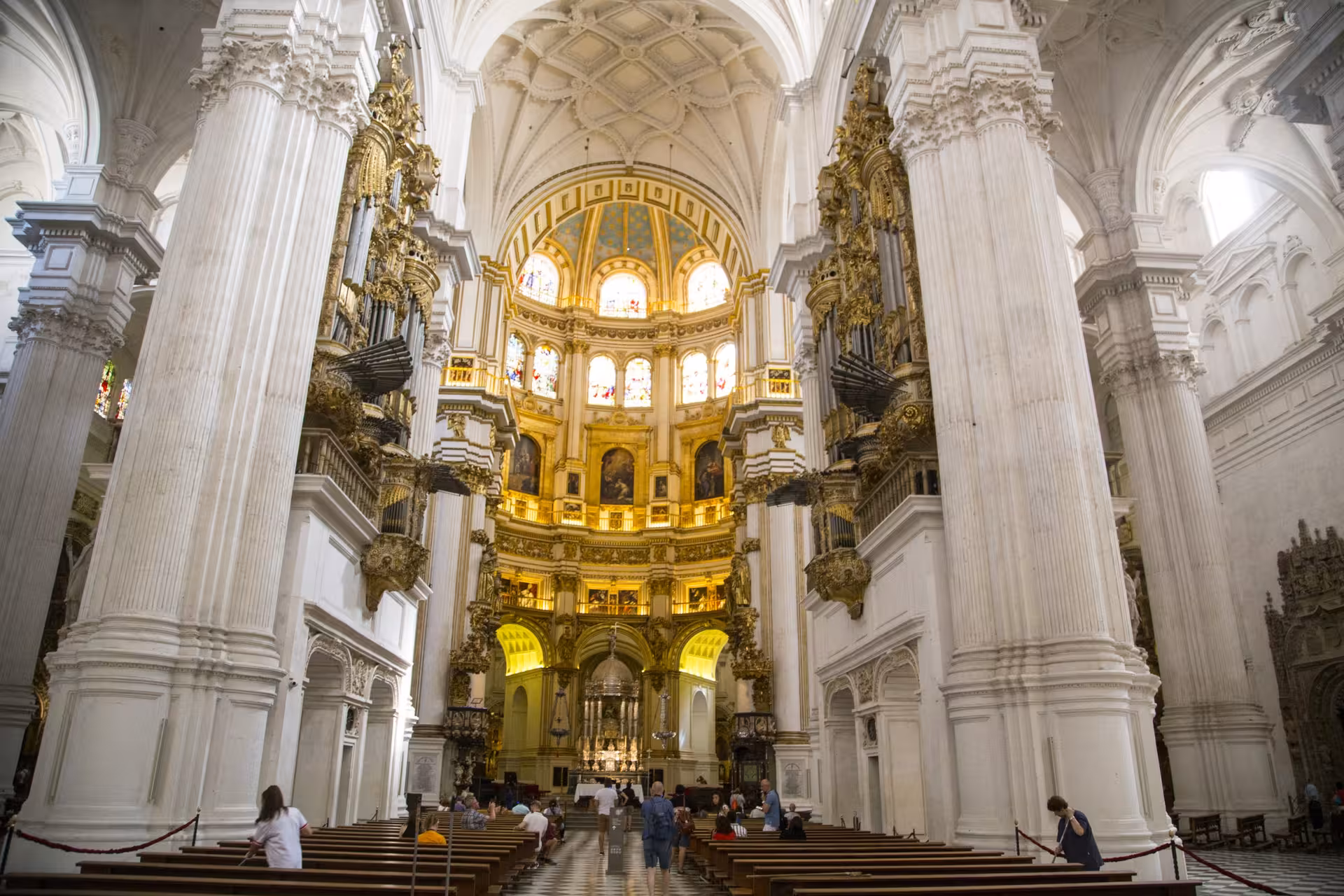 Intricate interior of Granada Cathedral showcasing ornate architecture on a guided tour stop.