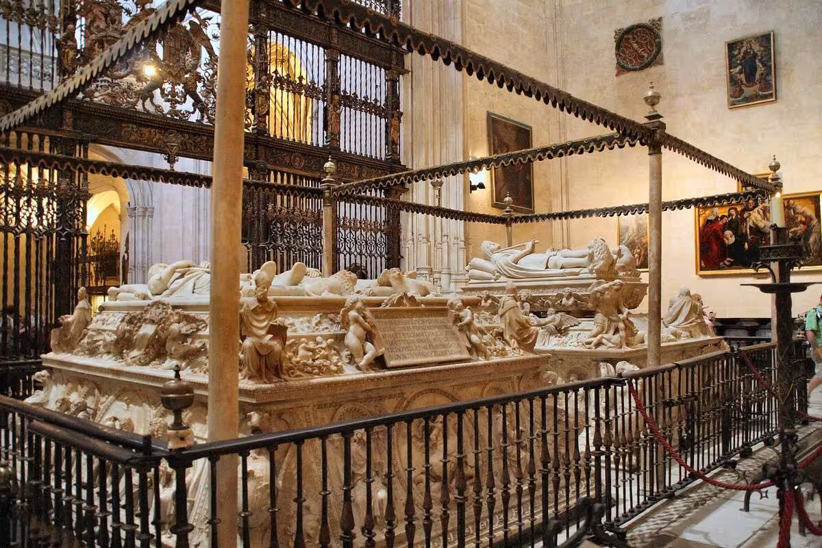 Ornate tombs in the Royal Chapel of Granada, featuring intricate sculptures and historical artworks in a sacred space.