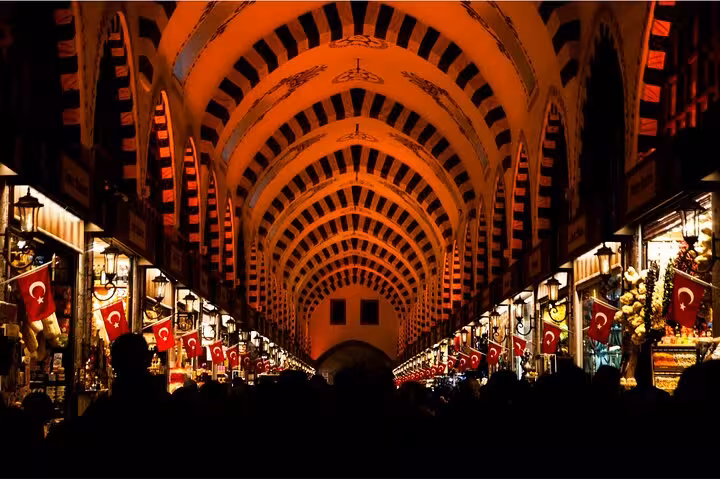 Grand Bazaar interior with arched ceiling and Turkish flags on a 2-day private guided Istanbul tour
