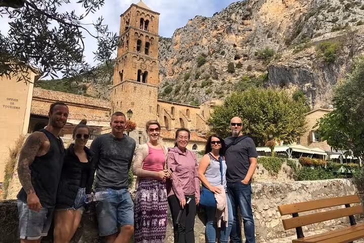 Group enjoying a visit to a historic village near the Grand Canyon of Europe with scenic mountain backdrop.