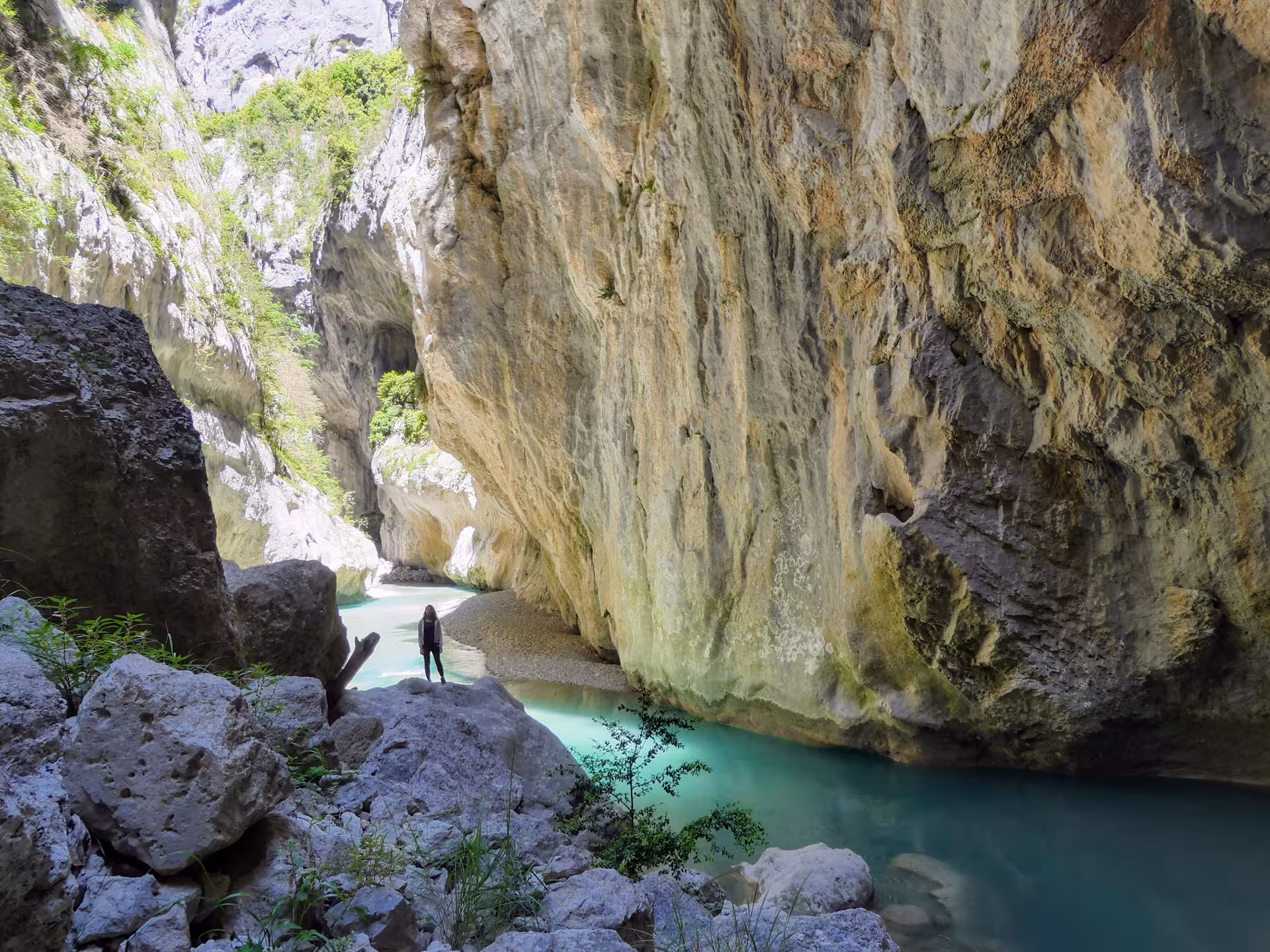 Hiker beside turquoise river under towering limestone walls in Gorges du Verdon on 3D/2N hotel tour