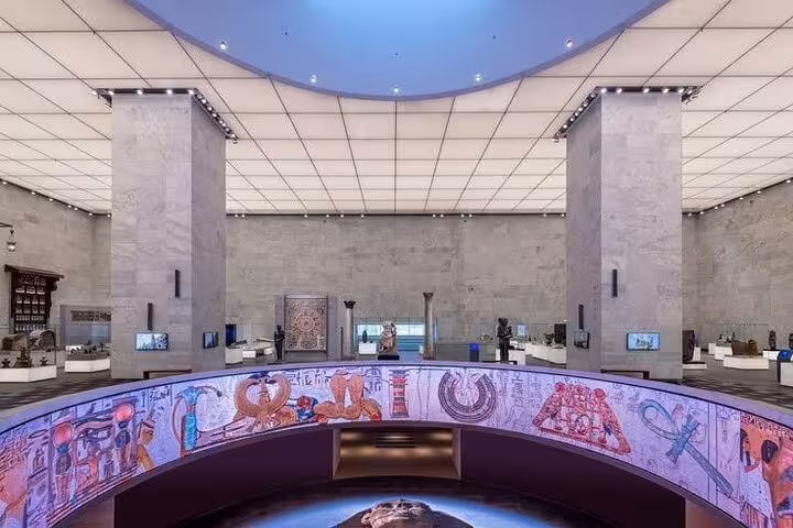 Grand Egyptian Museum main hall with ancient artifacts, included in Alexandria Port to Giza private tour