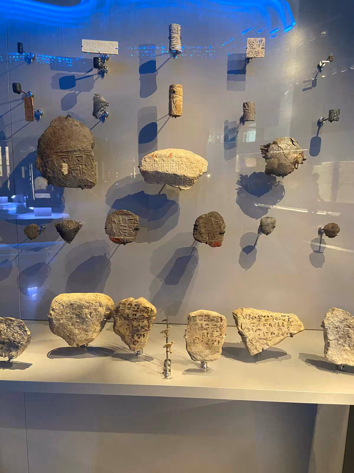 Ancient Egyptian inscribed stone fragments and seals exhibit inside the Grand Egyptian Museum Cairo tour