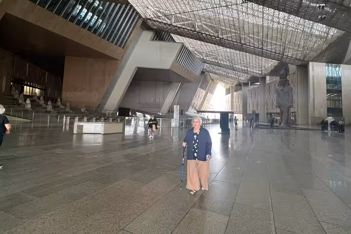 Spacious Grand Egyptian Museum atrium in Cairo on a private tour with guide, soaring roof and colossal statue