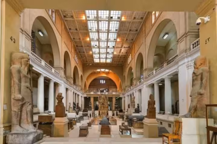 Grand Egyptian Museum gallery in Cairo with towering pharaoh statues, a highlight on a 2-day Cairo and Fayoum tour