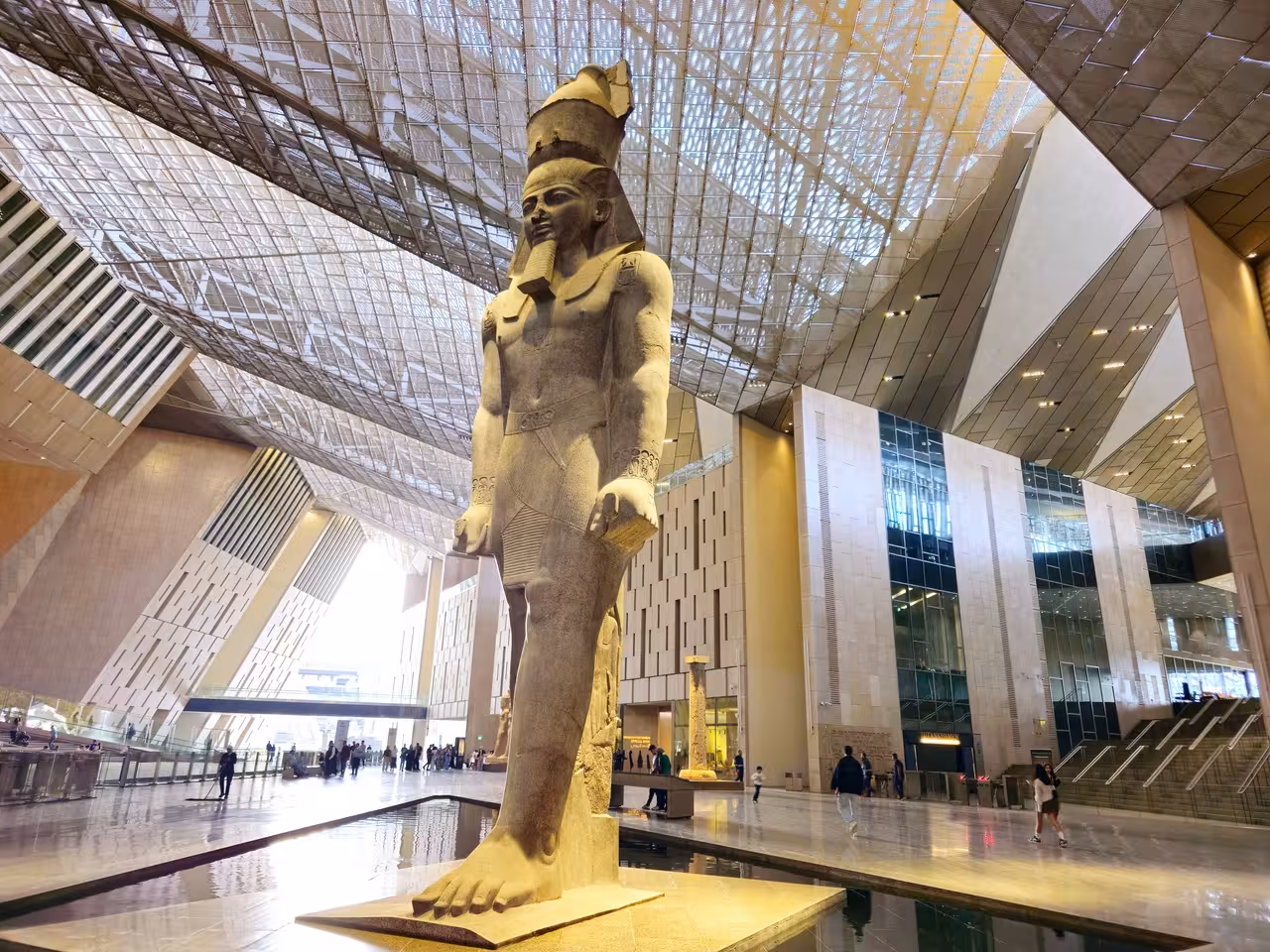 Grand Egyptian Museum Cairo interior with colossal pharaoh statue on Hurghada to Cairo day trip tour
