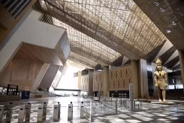 Grand Egyptian Museum Cairo atrium with colossal pharaoh statue, part of Sakkara and NMEC tour
