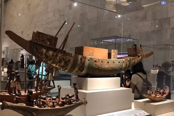 Ancient Egyptian wooden funerary boat exhibit inside the Grand Egyptian Museum, Cairo private tour with guide