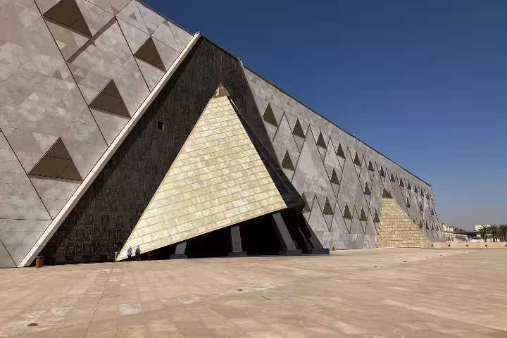 Grand Egyptian Museum Giza exterior with pyramid-shaped entrance, Cairo stop on Egypt Golden Triangle tour