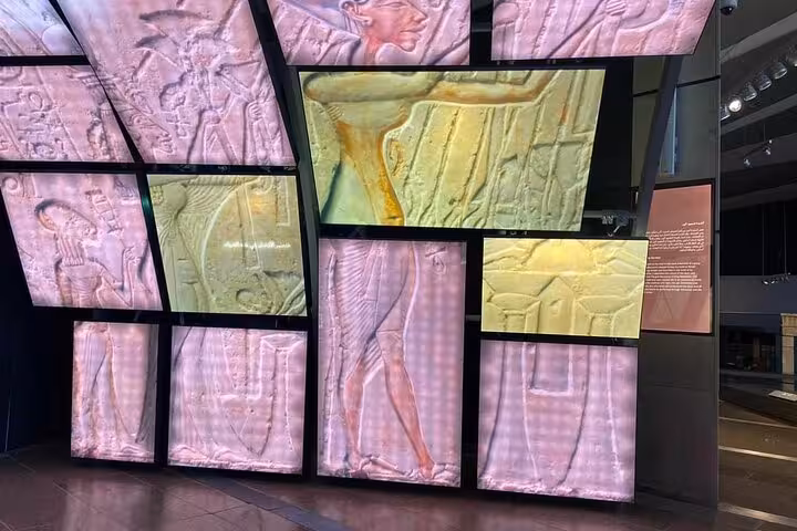 Immersive digital wall of ancient Egyptian reliefs inside Grand Egyptian Museum on Giza Pyramids day tour