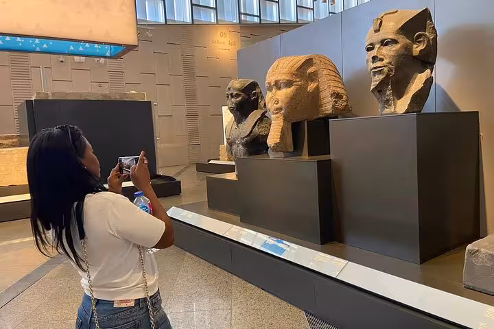 Grand Egyptian Museum gallery with ancient statues and artifacts, part of Giza Pyramids day tour with lunch