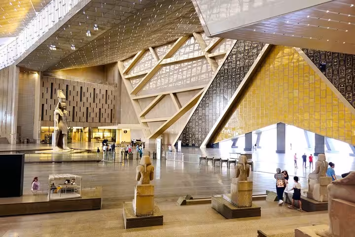 Wide view of Grand Egyptian Museum interior halls and statues, included in Sharm to Cairo flight tour
